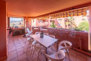 a room with a table and chairs on a balcony at Apartamento Punta del Faro in Torrox Costa