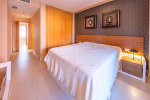 a bedroom with a large white bed in a room at Apartamento Punta del Faro in Torrox Costa +7 photos