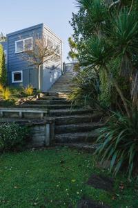a set of stairs leading up to a house at Cottage on Aotea in Dunedin