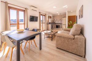 a living room with a table and a couch at Apartamento Chic in Frigiliana