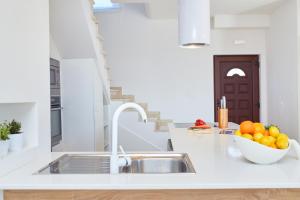 uma cozinha com um lavatório e uma tigela de laranjas em Villa Callista em Dubrovnik