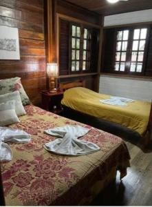 Кровать или кровати в номере Chalé Castelo Interlagos