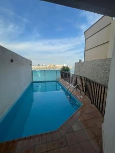 a swimming pool with a view of the water at سافانا امواج Amwaj savana in Half Moon Bay