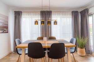 a dining room with a table and chairs at Modern brand new Apartment Torrevieja Centre 2 in Torrevieja +24 photos