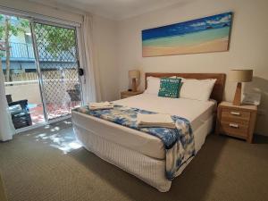 a bedroom with a bed and a large window at Mari Court Resort in Gold Coast