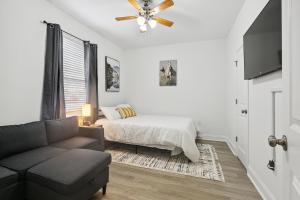 a living room with a bed and a couch at New Luxury 3BR w Jacuzzi in New Orleans