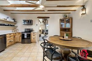 a kitchen and dining room with a wooden table and chairs at Rancho de La Luna Casita in Santa Fe