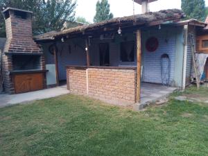 a brick house with a porch and a yard at Amanecer in Uspallata