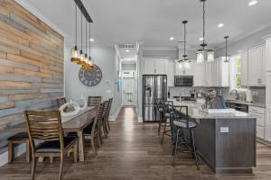 a kitchen with a large table and chairs at Maison by The Sea at Kure Beach in Kure Beach
