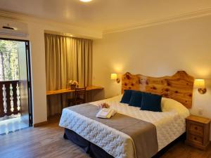 a bedroom with a large bed with a wooden headboard at Hotel Schneider in Treze Tílias