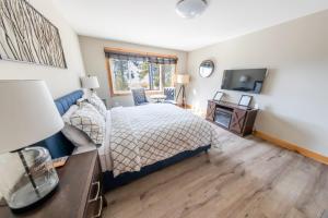 a bedroom with a bed and a desk and a television at Lakeside hotel room #8 in Kings Beach in Kings Beach