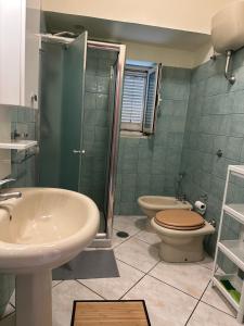 a bathroom with a sink and a toilet and a shower at In famiglia apartment and rooms for Pompei, Amalfi, Sorrento and Salerno in Sant'Egidio del Monte Albino +13 photos