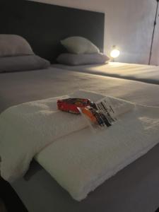 a white bed with a white blanket on it at Apart Hotel Montevideo in Montevideo