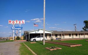 a motel with a car parked in front of a building at Ranger Motel in El Reno