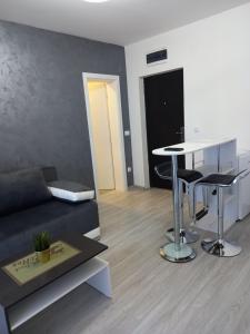 a living room with a couch and a table at Silver Lake Apartments in Veliko Gradište