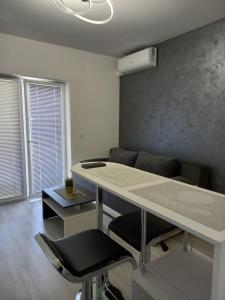 an office with a white desk and a chair at Silver Lake Apartments in Veliko Gradište