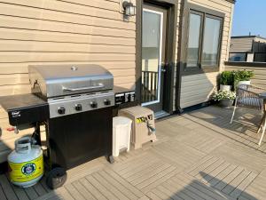 a grill on a patio on a house at Modern and Bright Luxury Home Centrally Located in Toronto’s GTA in Toronto