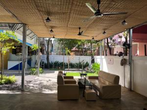 a living room with couches and a ceiling fan at Por Chey in Battambang