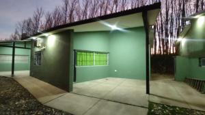 een leeg gebouw met een groene muur en verlichting bij Cabañas Berenice in Malargüe