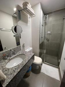 a bathroom with a sink and a shower and a toilet at Via Premiere Suite 710B in Rio de Janeiro
