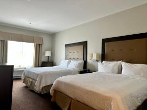 a hotel room with two beds and a window at Holiday Inn Express Vancouver North, an IHG Hotel in Vancouver