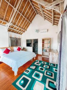 a bedroom with two beds and a rug at Tetebatu Flush Harmony in Tetebatu