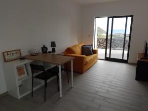 a living room with a table and a couch at Casa Bidarta in Faja Grande