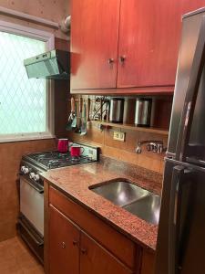 a kitchen with a sink and a stove at Departamento Recoleta. Inmejorable ubicación. in Buenos Aires