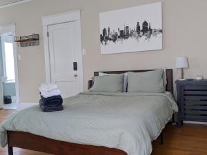 a bedroom with a bed and a picture on the wall at Sunny Efficiency In Historic Home in Durham