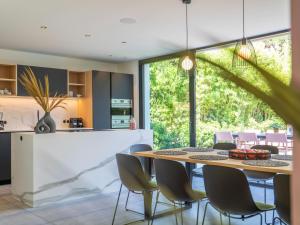 a kitchen and dining room with a table and chairs at Luxury holiday home in Kortrijk with wellness and heated pool in Kortrijk