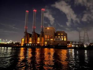 a factory by the water at night at Studio 54 Themed Boat St. Tropez in Providence