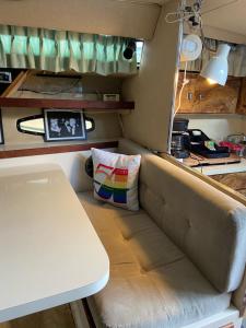 a couch and a table in a small room at Studio 54 Themed Boat St. Tropez in Providence