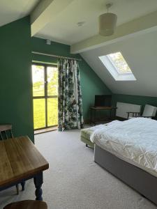 a bedroom with a bed and a large window at Stunning 1-Bed in Bruton Somerset stunning views in Bruton