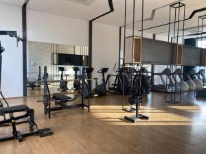 a gym with several treadmills and exercise bikes at Studio I Patteo Bosque Maia in Guarulhos