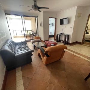 ein Wohnzimmer mit 2 Sofas und einem TV in der Unterkunft Apartamento familiar. in Cartagena de Indias