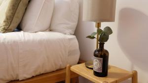 a bottle of wine on a table next to a bed at Peniche Supertubos Terrace in Peniche