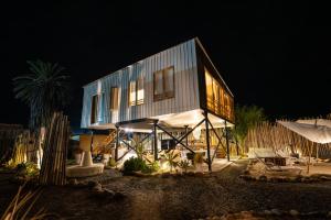 a house that is lit up at night at El Santuario in Paracas