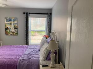 a bedroom with a purple bed and a window at Casa Cool in Braselton +31 photos