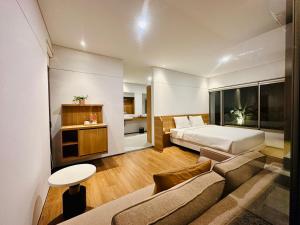 a hotel room with a bed and a couch at Bungalow Homes in Bandung