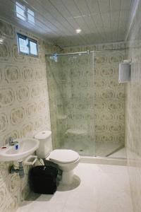 a bathroom with a toilet and a shower and a sink at Ecohotel La Reserva in Piojó