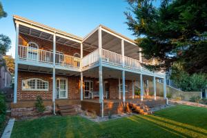 a brick house with a porch and a deck at Three Bears Cottage I Private Properties in Yallingup