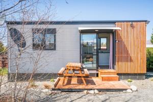 a house with a picnic table in front of it at Stunted Totara, Unit 5 in Twizel
