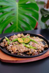 a dish of food with lime slices on a plate at Bambu Suites in Puerto Princesa City +13 photos