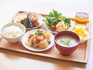 a tray with plates of food and bowls of food at Sotetsu Fresa Inn Kobe Sannomiya in Kobe