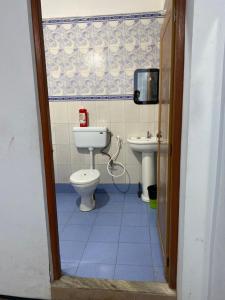 a bathroom with a toilet and a sink at Mount Olive in Darjeeling