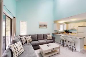 a living room with a couch and a kitchen at Fairway Village Paradise in Myrtle Beach