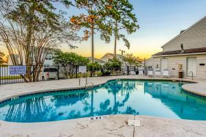 a swimming pool in front of a house at Fairway Village Paradise in Myrtle Beach