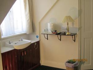 a bathroom with a sink and a window at Landguard House Bed Only in Southampton