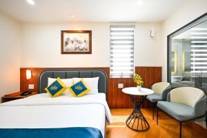 Postel nebo postele na pokoji v ubytování PLUS VUNG TAU HOTEL
