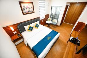 Postel nebo postele na pokoji v ubytování PLUS VUNG TAU HOTEL